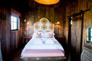 a bedroom with a bed in a wooden room at Iris - The Nook Lodges in Nantwich