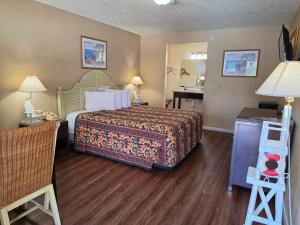 a hotel room with a bed and a desk at San Luis Inn and Suites in San Luis Obispo