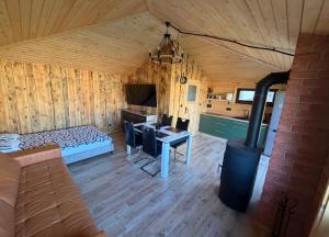 a room with a couch and a table and a stove at Pokoje Gościnne Nad Jeziorem in Rajgród