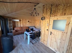 a living room with a couch and a table and a door at Pokoje Gościnne Nad Jeziorem in Rajgród