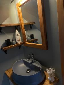 a bathroom with a blue sink and a mirror at Villa Monte Shpirag in Berat +9 photos