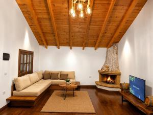 a living room with a couch and a fireplace at Villa Monte Shpirag in Berat