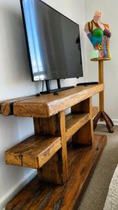 a tv sitting on top of a wooden tv stand at Acogedor departamento en La Serena in La Serena +4 photos