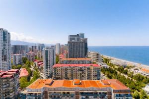 an aerial view of a city with buildings and the ocean at Orbi City Panoramic Sea View Balcony in Batumi