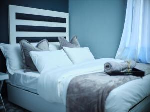 a bed with white sheets and pillows in a room at P Daisy in Rundu