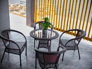 three chairs and a table with a plant on a patio at P Daisy in Rundu