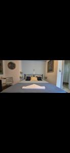 a bedroom with a large bed with a blanket at Hera's Hideaway in Samos +8 photos