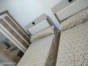 two beds in a room next to a bedsenalsenalsenalsenalsenalsenalsenal at Holiday Home Matrouh in Marsa Matruh +10 photos