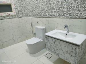 a bathroom with a toilet and a sink at Holiday Home Matrouh in Marsa Matruh