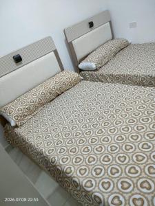 two beds sitting next to each other in a bedroom at Holiday Home Matrouh in Marsa Matruh