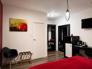 a room with a red bed and a red rug at Ladybugs Apartments in Palm-Eagle Beach