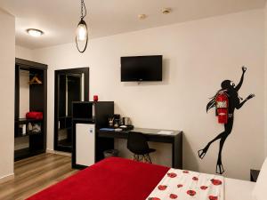 a room with a bed with a statue of a woman on the wall at Ladybugs Apartments in Palm-Eagle Beach