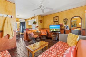 a living room with a couch and a tv at Blue Seas Courtyard in Fort Lauderdale