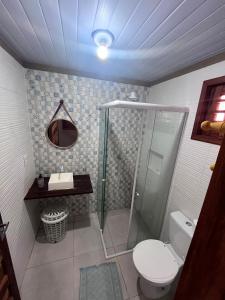a bathroom with a shower and a toilet and a sink at Mar Doce Lar - Praia Macapa in Luis Correia +26 photos