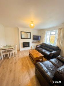 a living room with a couch and a table at Joni Bungalow-2-Bedroom HOME in Slades Green
