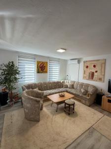 a living room with a couch and a table at VillaH Weekend House in Visoko