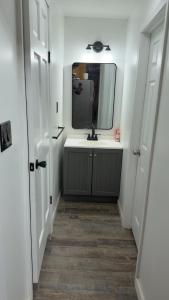 a bathroom with a sink and a mirror on the wall at A J House in Plano +28 photos