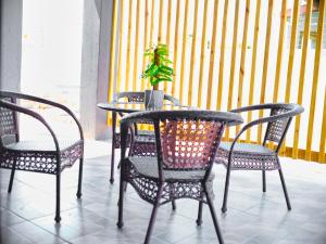 a table and chairs with a potted plant on a balcony at P Daisy in Rundu
