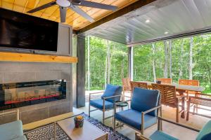 a screened porch with a fireplace and blue chairs at Blue Ridge, McCaysville, Rafting, Tubing, Secluded in Copperhill