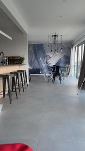 a dining room with a table and some chairs at Black Box Bach in Coopers Beach