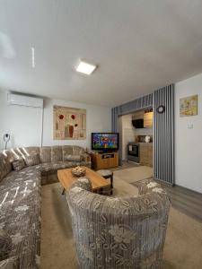 a living room with a couch and a table at VillaH Weekend House in Visoko +26 photos