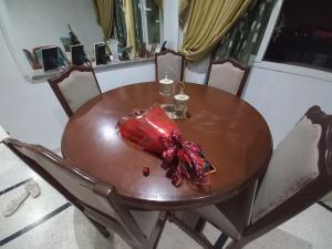 a wooden table with a red present on it at Nour 2 in Le Bardo +4 photos