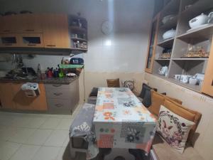 a kitchen with a table with a box on it at Nour 2 in Le Bardo