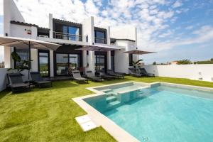an image of a house with a swimming pool at White Pampas Tiny houses in Paralia Dionysiou
