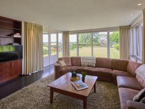 a living room with a couch and a coffee table at Laurahoeve in Nederweert