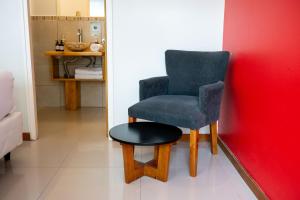 a blue chair and a stool in a room at Hotel Chardonnay in Tupungato +20 photos