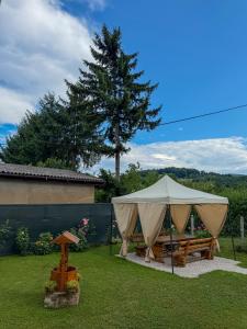 a tent with a picnic table in a yard at VillaH Weekend House in Visoko