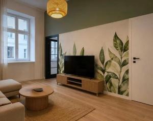 a living room with a flat screen tv on a wall at BOOGIE Home Nawrot 13 in Łódź