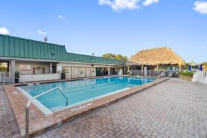 a swimming pool at a resort with a building at Studio, kitchenette, pool & Tiki Bar in Sarasota