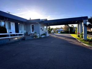 an empty parking lot in front of a house at Merimbula Coastline Motel in Merimbula