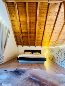 a bedroom with a bed in a room with wooden ceilings at Villa Silent Bay Lučice in Milna
