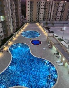 an overhead view of three pools of blue water at Aparta Hotel Casacrislaye Santa marta in Santa Marta