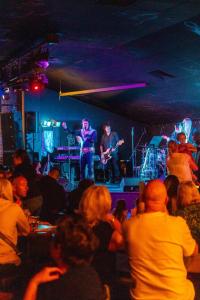 a crowd of people watching a band in a concert at The Casa Descanso in Rhyl +171 photos