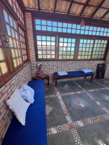 a room with two beds and a person sitting in it at Mar Doce Lar - Praia Macapa in Luis Correia