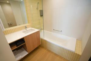 a bathroom with a tub and a sink and a shower at 클리프비치 in Sangun-ni +31 photos
