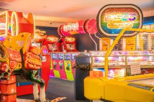 a clown standing in front of a pinball machine at The Casa Descanso in Rhyl