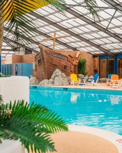 a swimming pool with a house in the middle at The Casa Descanso in Rhyl