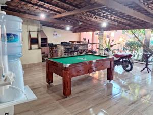 a room with a pool table and a motorcycle in it at Hospedagem Aconchego Do Lar in Barreirinhas