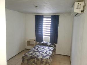 a small room with a bed and a window at Casa completa con 3 habitaciones in Monterrey