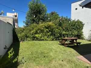 a picnic table sitting on the grass in a yard at Departamento Jumace in Federación