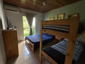 a bedroom with two bunk beds and a television at Departamento Jumace in Federación