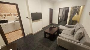 a living room with a couch and a table at SR Hotel in Salalah +1 photo