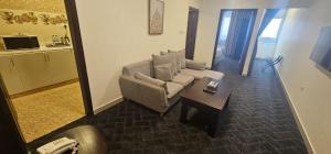 a living room with a couch and a coffee table at SR Hotel in Salalah