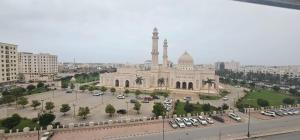 a large building with a mosque in a city at SR Hotel in Salalah