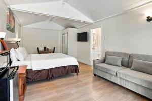 a hotel room with a bed and a couch at Carmel Resort Inn in Carmel