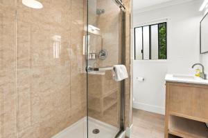 a bathroom with a shower and a sink at Carmel Resort Inn in Carmel +163 photos